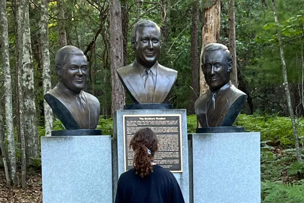 Family member at UAW Family Scholarship looking at the Reuther brothers' statues